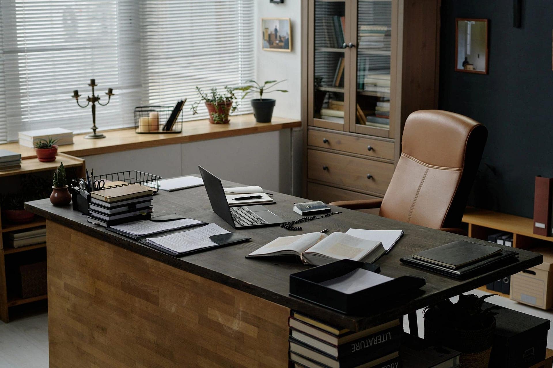 A practical workspace with a laptop, notebooks and business papers, from the existing Vibe Coding Services page